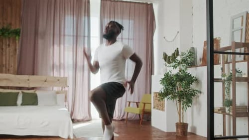 Man Doing High Knees in Bedroom for Exercise