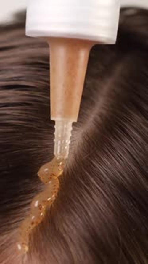 Hair Treatment Application Close Up on Dark Hair