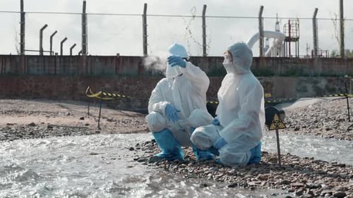 Ecologist Sampling Water From River with Test Tube Glass and Have White Smoke