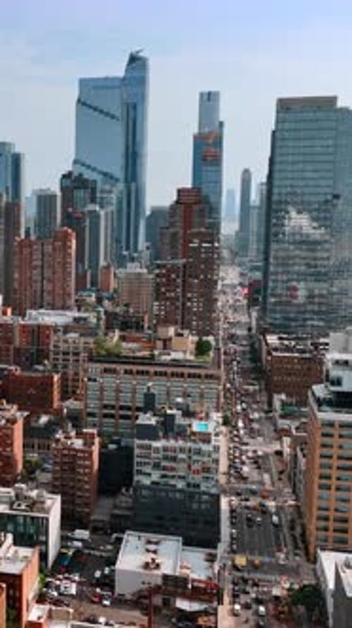 Usual building contrasting with gorgeous skyscrapers. Drone flight above New York on sunny day.
