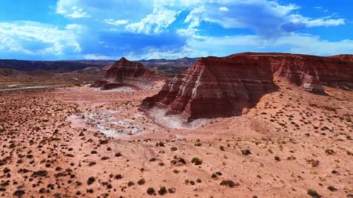 Flight along the red ridged canyons in the hot desert.