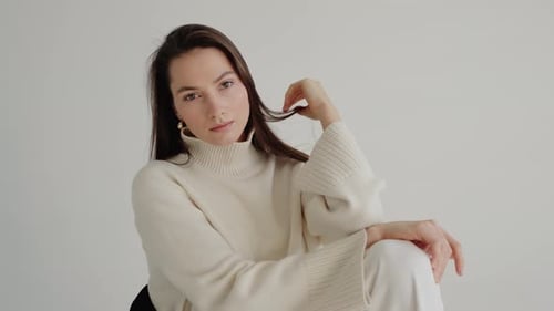 Woman Posing in Sweater in Studio Setting