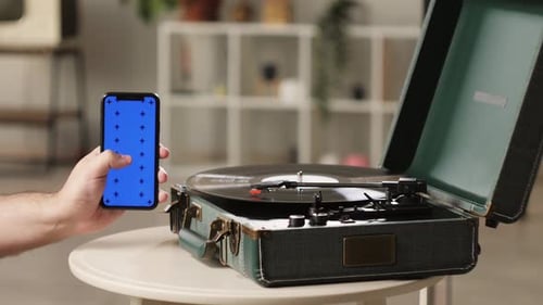 Vinyl Record with Phone and Blue Chroma Key Closeup