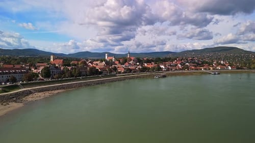 Low-level drone flight above the Danube River toward the colorful town of Szentendre, Hungary.