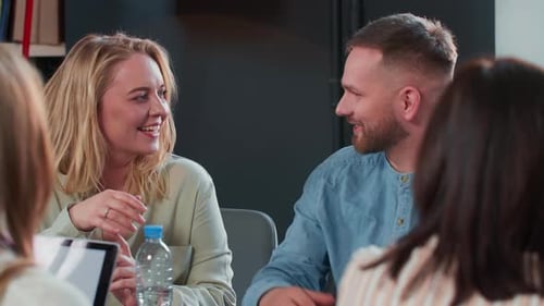 Enthusiastic Team Meeting Around Table in Office
