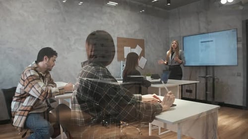 A Young Student Raises Their Hand During a College Lecture in Order to Ask the Teacher a Question