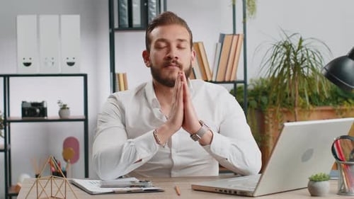 Businessman Working on Laptop Meditating Doing Yoga Breathing Exercise in Lotus Position at Office