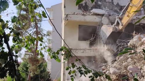 building demolished with a shovel