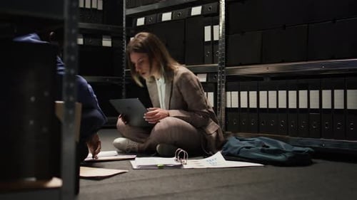 Business Professionals Collaborating on Floor in Office Storage