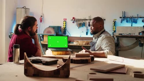 Joyous Cabinetmaker Look Over Blueprints Schematics on Isolated Screen Laptop