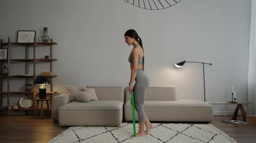 Woman Exercising with Resistance Band at Home