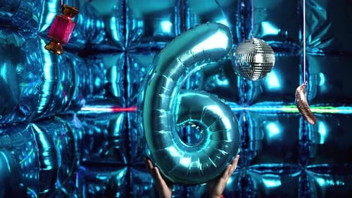 Hands Holding Blue Number Six Balloon