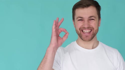 Happy Man Gives OK Hand Gesture