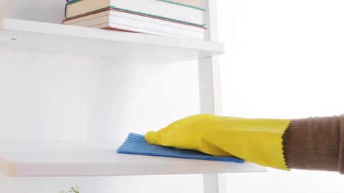 Cleaning shelf with spray and rag close-up