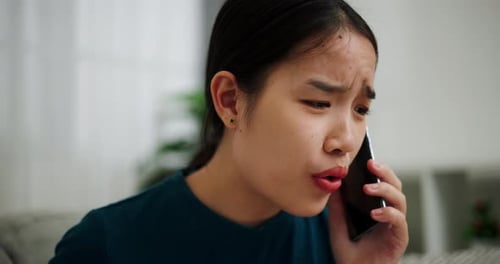Young Woman Arguing On the Phone Indoors