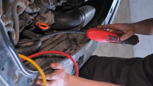 Mechanic Running Car Engine Diagnostics with Tool