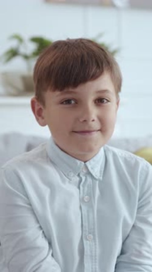 Blond Boy Smiling in Button-Down Shirt, Close-Up