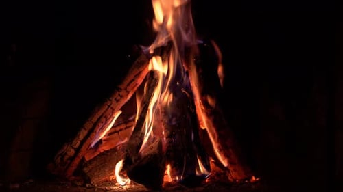 Cozy Fire Burning in a Dark Fireplace