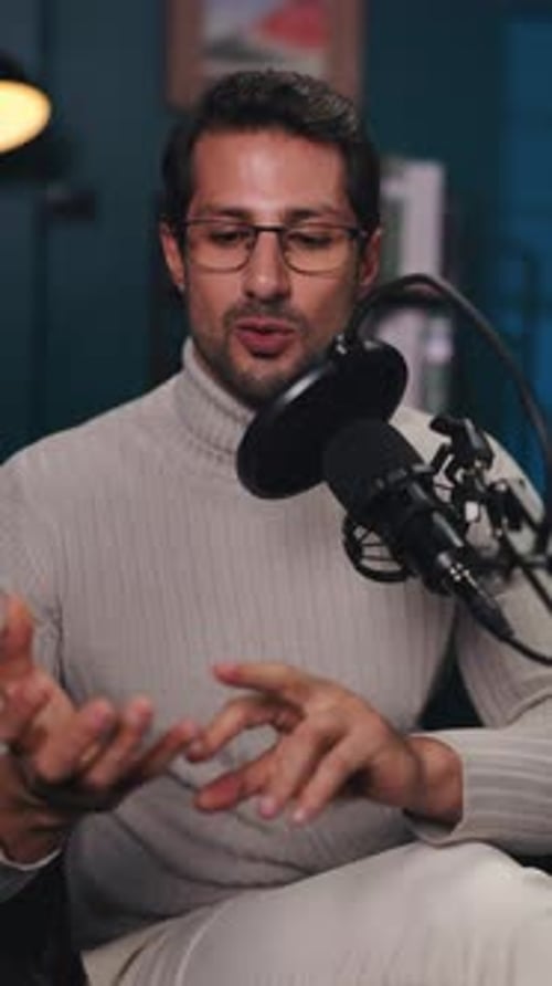 Portrait of Happy Young Man Talks in Mic During Podcast in Radio Studio