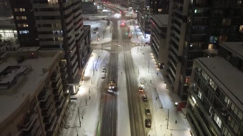Snowplow truck clearing snow at night in Mississauga, Ontario