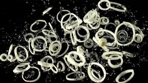 Rings of Onion Falling With Water Drops