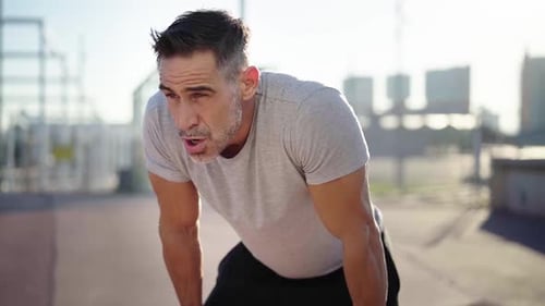 Man Rests After Outdoor Exercise in Sunlight