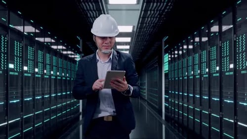 Front View of Asian Businessman Use Tablet While Walking in Data Center