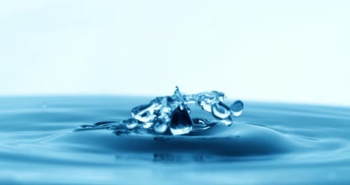 Drop of water falls into a drop of water in a super slow motion. Shot on super slow motion 1600 fps.
