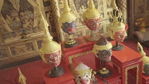 Top view of beautiful ancient traditional Thai pattern Pantomime or Khon masks are set up on shelf