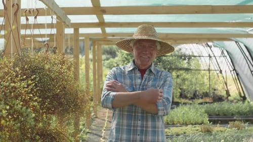 Portrait of Senior Man in Straw Hat at Plant Nursery