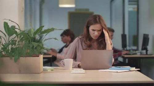 Business Woman Reading Bad News on Laptop Computer in Office. Portrait Of