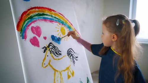 Little Girl Painting Rainbow and Unicorn Picture