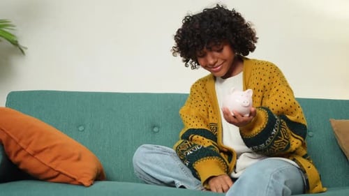 Saving Money Investment for Future African American Girl Holding Pink Piggy Bank and Putting Money