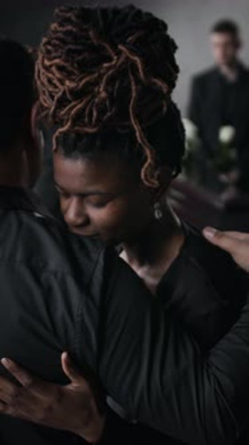 Woman Being Comforted at Funeral Gathering