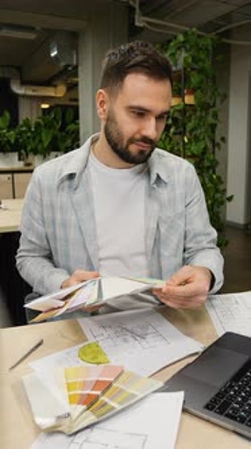 Professional Designer Choosing Colors From a Palette for Interior Design Project
