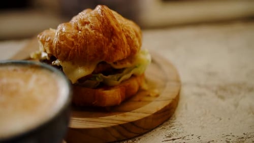 Close Up of Croissant Sandwich and Latte