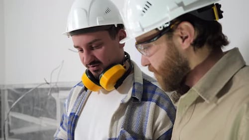 The Construction Engineer and the Customer Discuss the Work Done