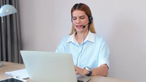 Professional young business woman working and meeting online in modern home office.