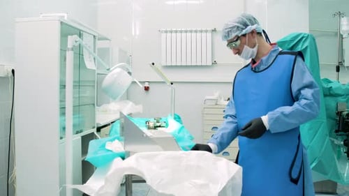 Surgeon Prepares Medical Equipment in Hospital Operating Room
