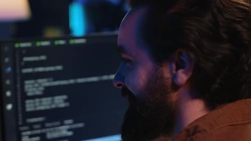 Upbeat Teleworking IT Professional in Apartment Writing Lines of Code Close Up