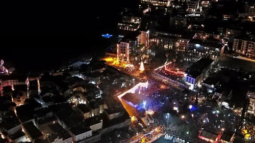 Crowd Gathers for Christmas Celebration at Night