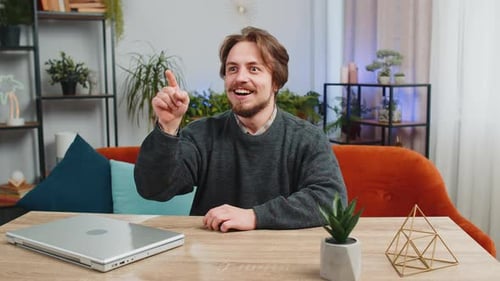Young Adult Man Having an Idea at Home