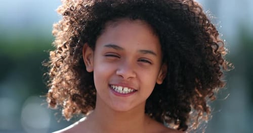 Beautiful preteen girl child portrait smiling outside, black African descent