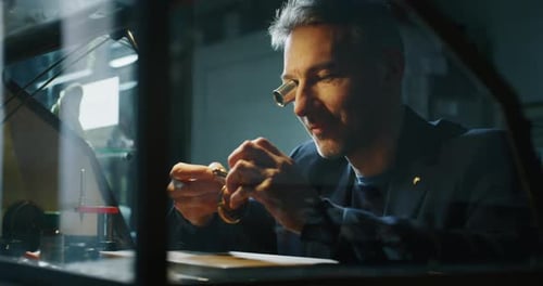 Man Repairs Intricate Watch Mechanism With Magnifier