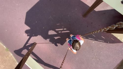 overhead shot of a child swinging on a swing