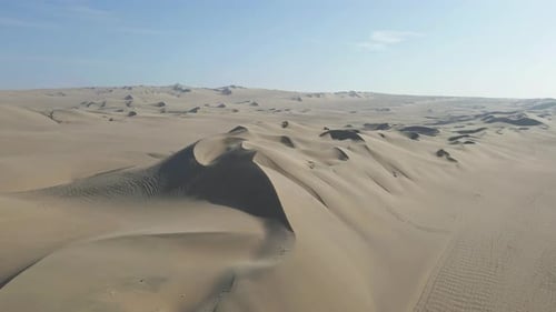 Drone gracefully advances, capturing the beauty of the desert dunes near Huacachina. A slow, mesmeri
