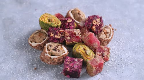 Concept of Traditional Cuisine and Local Dishes Oriental Sweets Turkish Delight Rotate on a Gray
