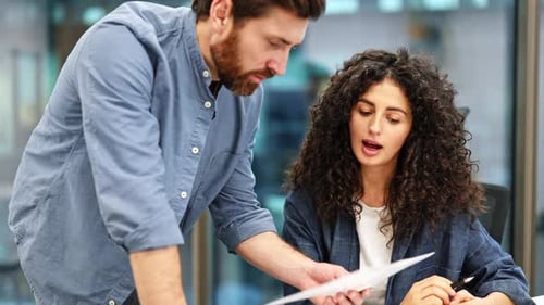 Business Colleagues Reviewing Documents in Modern Office