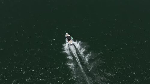 Speed boat with people roaring across the Sea at high speed