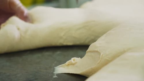 Dough Being Cut on Work Surface Close Up